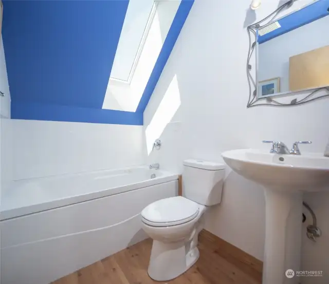 upper level bath with jetted tub and skylight