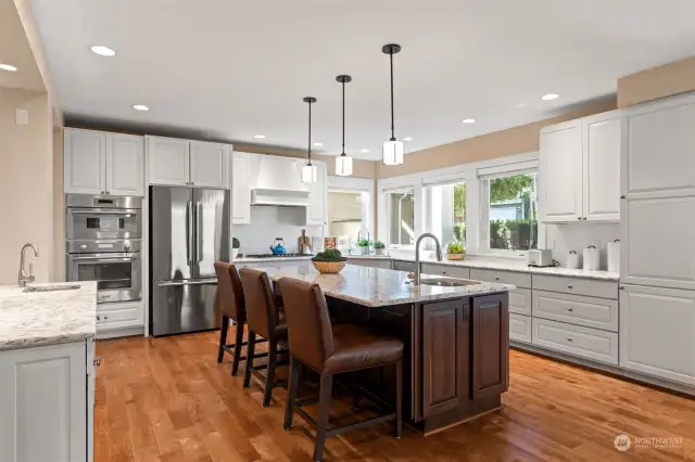 The stylish & bright kitchen is designed with an expansive entertaining island & stainless steel appliances