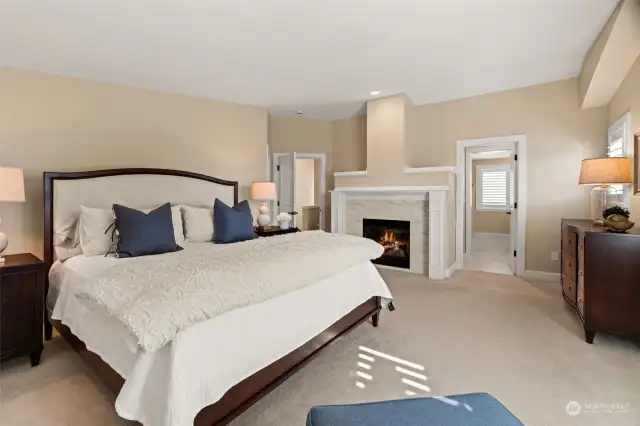 Primary Suite with a gas fireplace and large walk-in closet