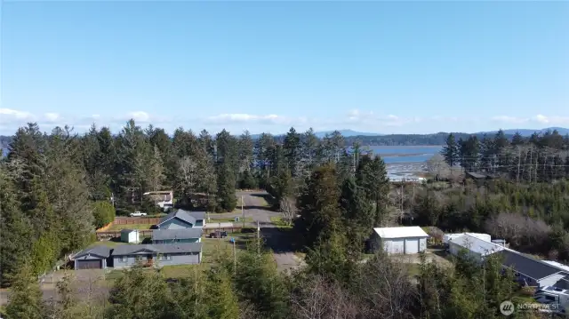 Drone shot looking towards bay from right at the east side of property
