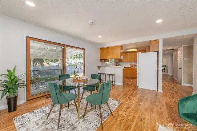 The open-concept family and dining room flows seamlessly to the outdoors, thanks to a large sliding glass door that opens to a covered patio—perfect for year-round entertaining or quiet mornings with coffee