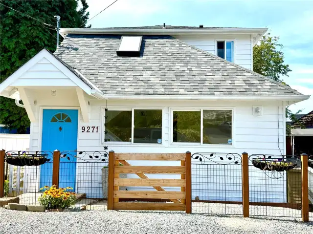 Cute cottage with a new roof and sweet little front porch.