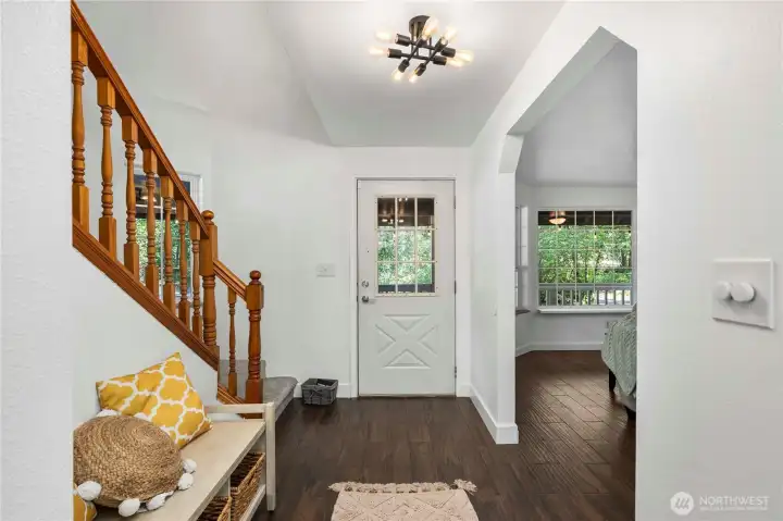 Entry with living room on one side and stairs on the other.