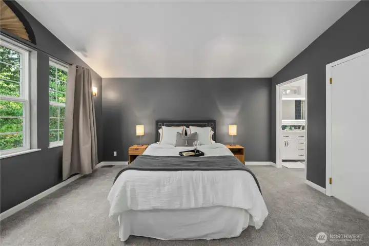 Primary bedroom featuring walk-in closet and remodeled en-suite bath.