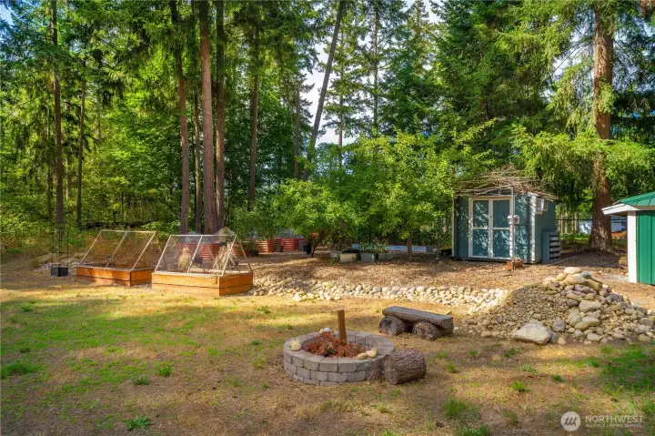 Garden beds, shed and firepit make this yard ready to utilise!