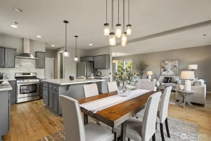 Open-concept kitchen, dining, and living area designed to keep everyone connected while enjoying meals with serene views of the surrounding greenery.( Staged picture)