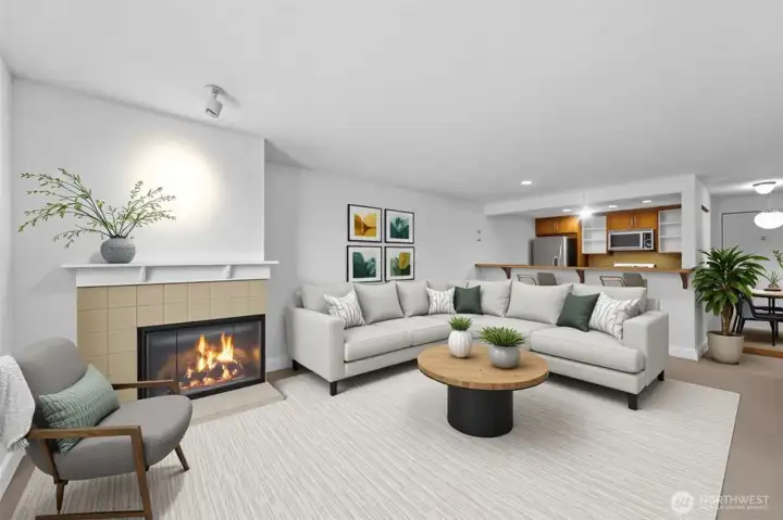 Wood burning fireplace in the living room makes a great focal point with the overhead accent light. Owner just installed new carpet and painted the entire interior.  Natural light fills the space and the open floor plan is great for entertaining or just living the life you deserve.