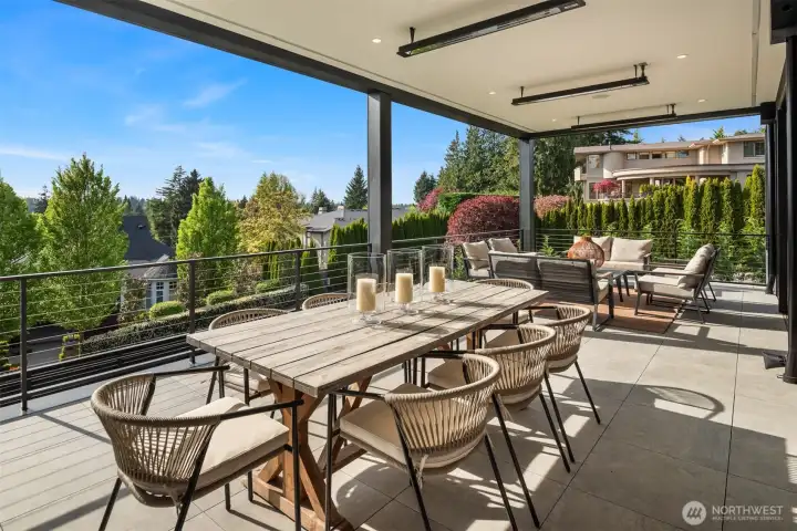 Expansive covered terrace offers year-round entertaining with multiple seating areas and tranquil views.