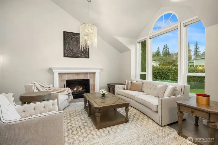 The formal living room boasts a lovely granite faced gas fireplace and wood molding trim.