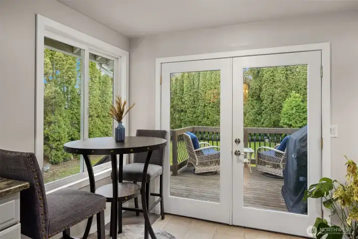 French doors past the breakfast nook lead to the deck, patio and large, private back yard.