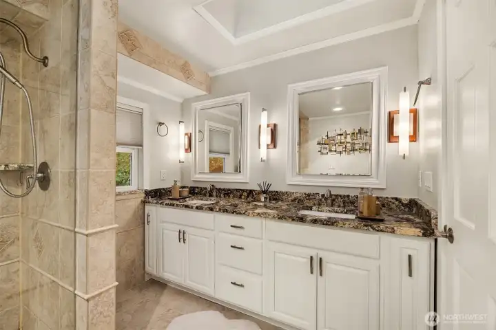 The primary bath is highlighted by wonderful surround tile floors and shower detail plus rich granite countertops and freshly painted cabinetry.