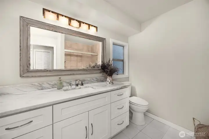 The full bath upstairs is shared by the two bedrooms and has so much room and cabinetry.