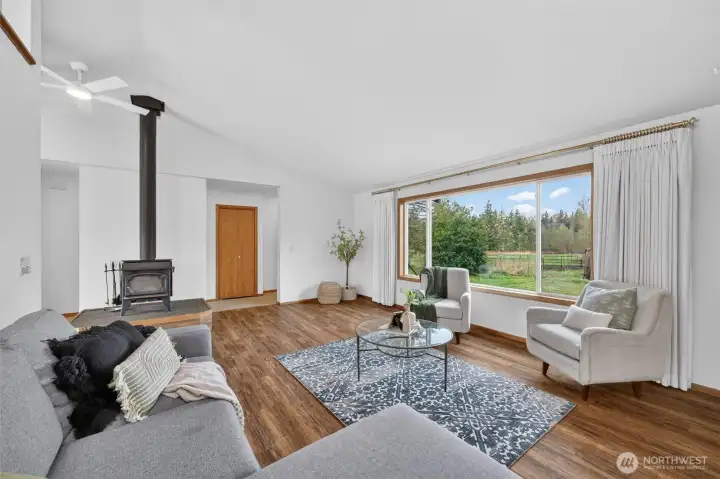 The large living room overlooks the tree lined pastures, providing a perfect background for conversations around the fire, slow mornings, and relaxing evenings.