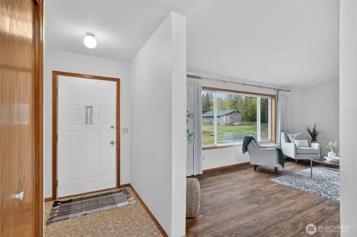 View of the front door to the left, which opens into the living room.