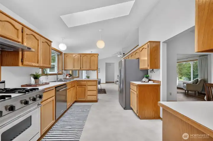 The kitchen is bright an open, with skylights brining in the natural light, abundant storage, and stainless appliances.