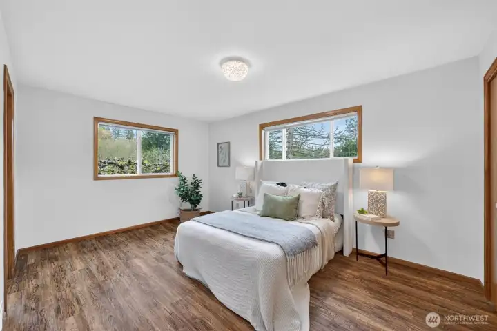 Primary bedroom with LVP flooring.