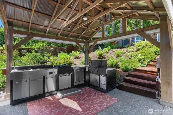 FULL Large outdoor kitchen located just outside of the main home kitchen. Remote Screens make things easy
