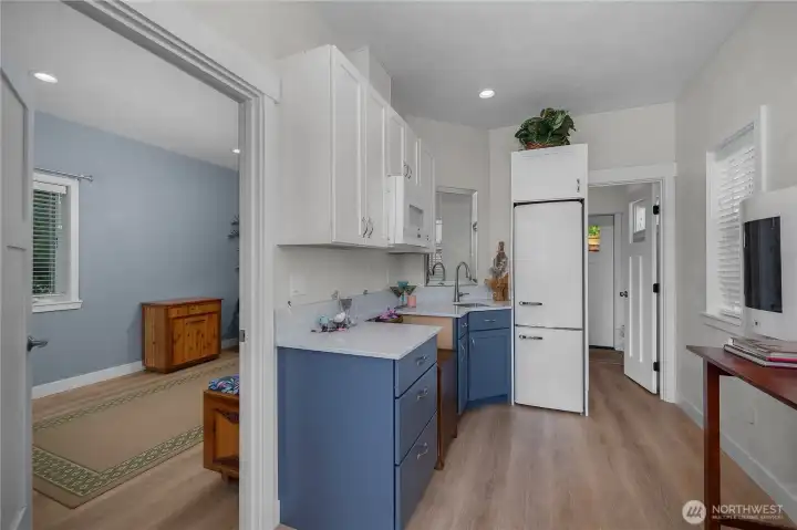 The upper-level private-entry studio retreat features water views, a kitchenette area, electric fireplace, and custom tile shower, making it ideal for creative pursuits, a wellness practice, home office, art studio, guest retreat, or other flexible-use opportunities.