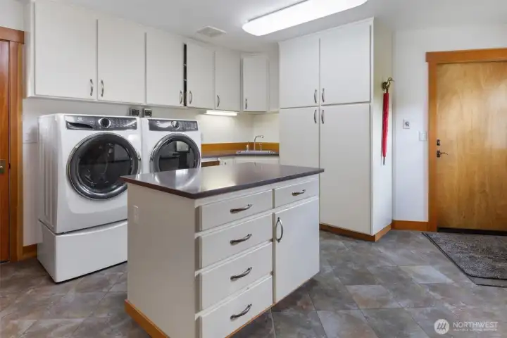 Laundry with island and sink, garage access Laundry with island and sink, garage access