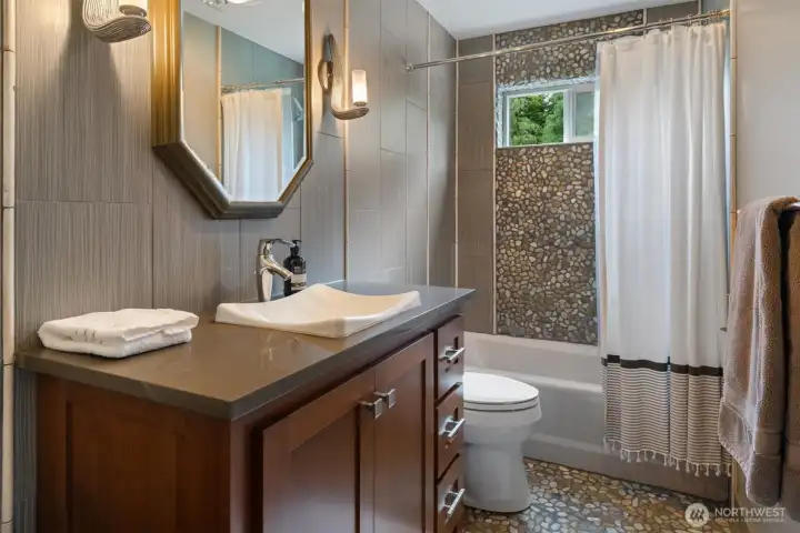 Upstairs full bath - smooth pebble floor and enclosure Upstairs full bath - smooth pebble floor and enclosure