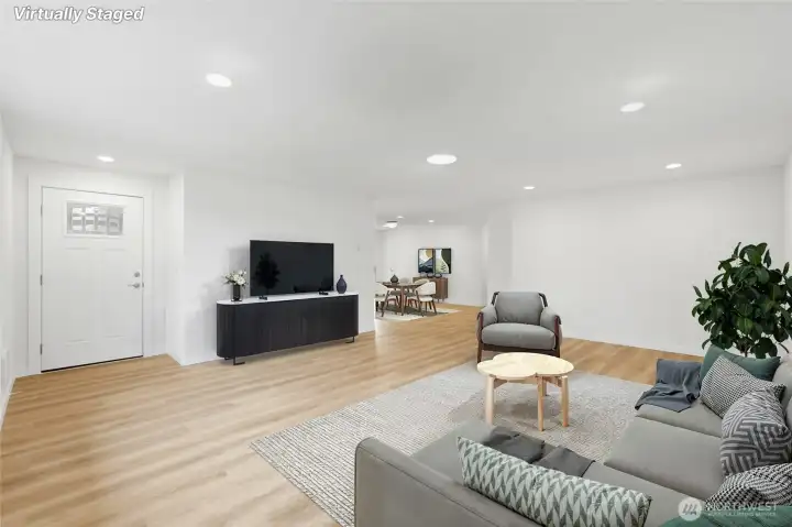 Another view of the living room looking toward front door & dining room in the background.
