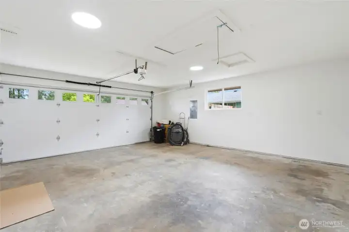 Finished two-car garage features brand new garage door with windows, automatic door opener and attic crawlspace access.