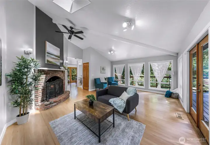 Vaulted living room ceilings and a wood burning fireplace.