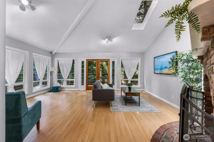 Walls of windows fill the living room with natural light.
