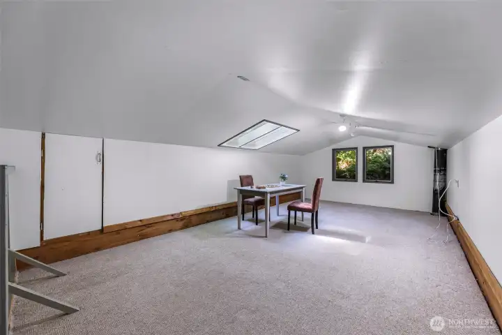 Approximately 437-square-foot loft above the garage provides incredible flex space.