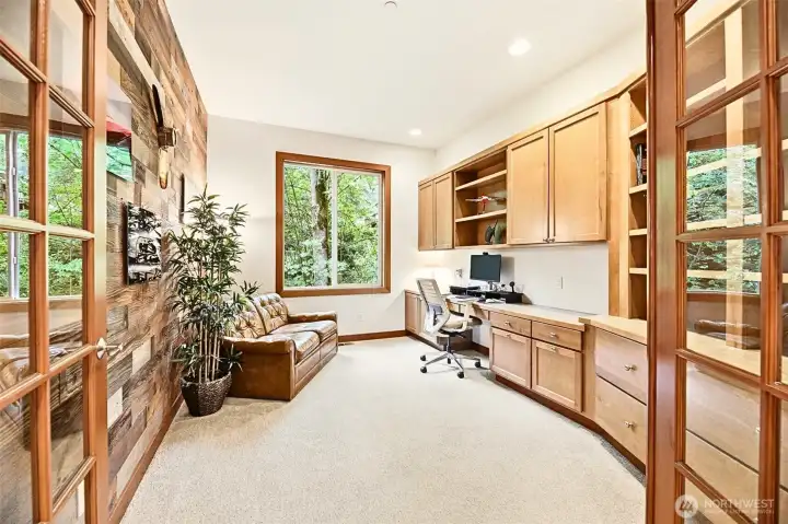 French doors into the office with built in custom cabinets and a private wooded view. French doors into the office with built in custom cabinets and a private wooded view.