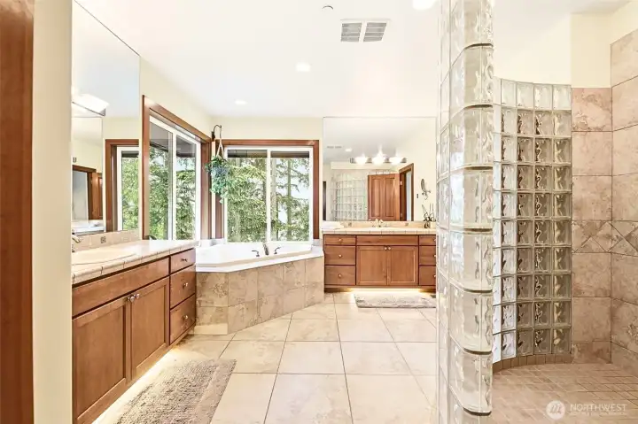 Spa-inspired primary bathroom is a beauty! Another opportunity to take in the view of the surrounding trees and the sparkling water outside your window. Spa-inspired primary bathroom is a beauty! Another opportunity to take in the view of the surrounding trees and the sparkling water outside your window.