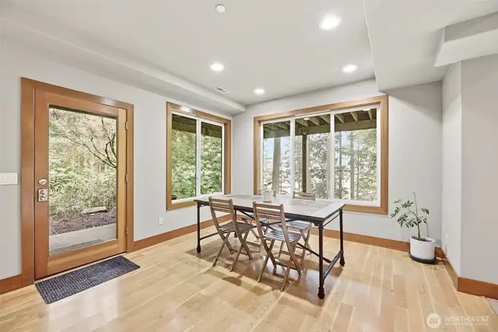 Dining room on lower level with access to patio and lake views. Dining room on lower level with access to patio and lake views.