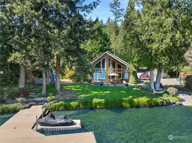 View toward the Home Shows the New Jacuzzi Spa to the Right, the Expansive PNW Landscape Designed by a Master Gardener, Supersized Entertainment Patio, & a Portion of the Private Boat Launch!