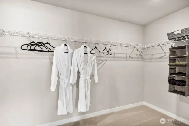 Primary walk-in closet.  Photo is representational. Actual home is under construction and finishes and colors will vary. See site agent for details.