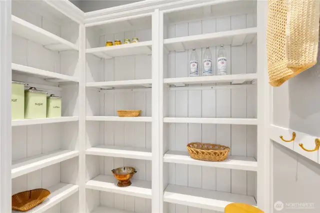 Pantry space; every cook's dream. Custom wood shelving.