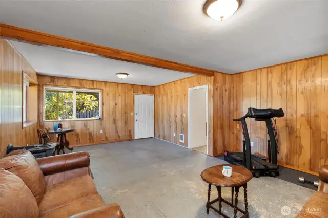 Seamlessly blend indoor and outdoor living with this versatile lower-level room, providing a separate entrance that flows effortlessly onto a back porch.