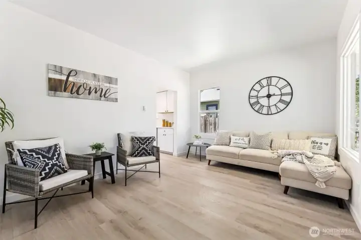 Bright and stylish living space featuring fresh paint and easy-care LVP flooring throughout.
