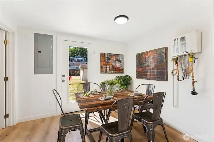 This photo is virtually staged. While there is room for a table and chairs, you'd need something a bit smaller in this space.