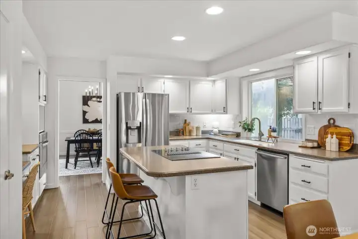 Fresh painted cabinetry, new hardware, stainless appliances, and abundant storage.