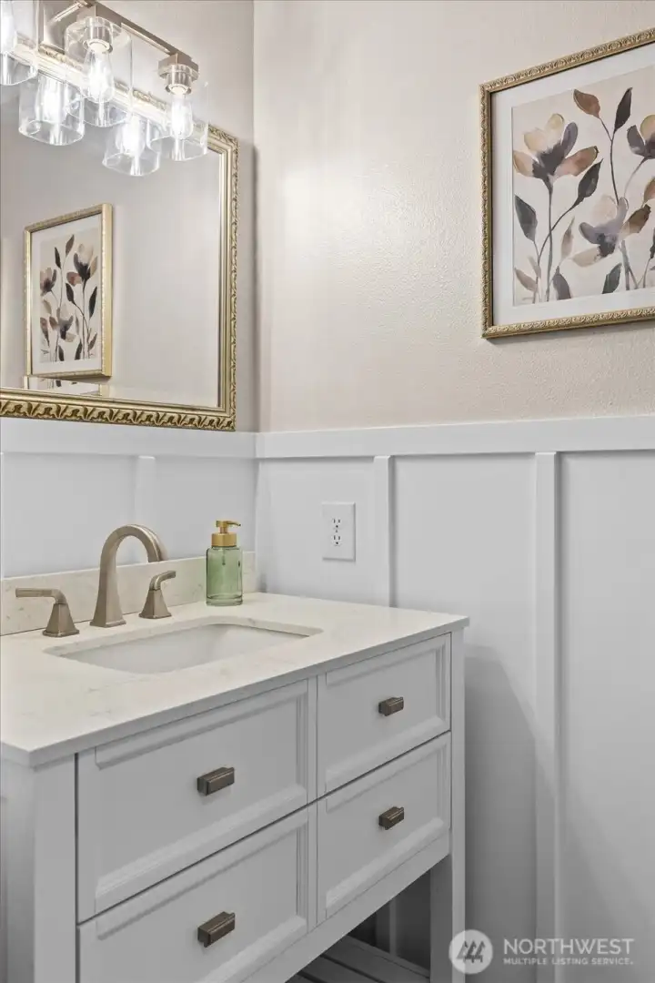 Thoughtfully updated with a newer vanity, modern lighting, and board-and-batten wall detail for added character.