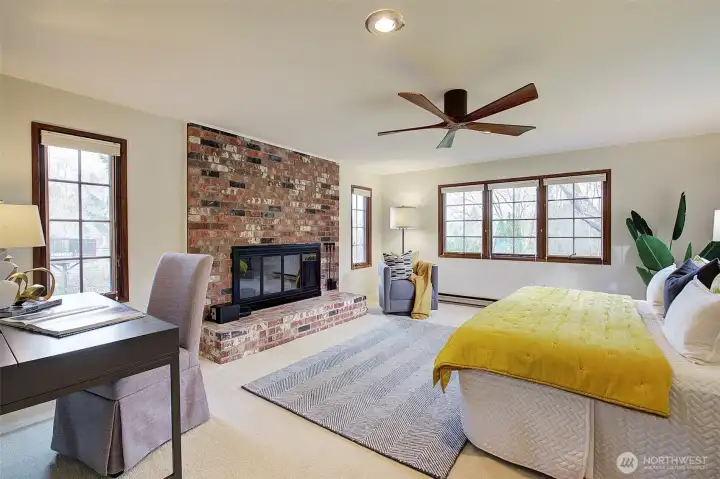 Very spacious primary with its own wood burning fireplace, wood wrapped windows and set at end of hall for privacy.