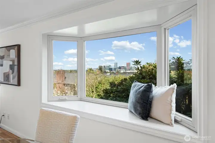 Framed by a stunning bay window, take in sweeping views of the Bellevue skyline from the comfort of your own home. Crisp white millwork, crown molding, and a spacious window seat create the perfect spot to relax and enjoy the scenery.