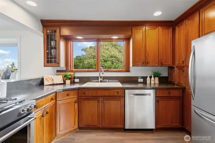 Solid cherry cabinetry, stainless appliances, and generous prep space bring style and efficiency together. Enjoy a unique view from the sink, where you can take in the Bellevue skyline while handling daily tasks.