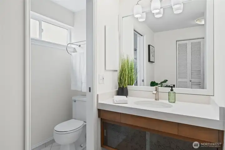 The Primary ensuite bath with a sleek vanity, quartz countertop, and modern fixtures. A dedicated shower and clean finishes create a streamlined space for daily routines.