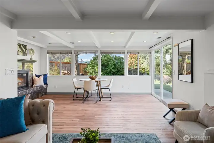 Open layout connects seamlessly to the patio through sliding glass doors, offering easy indoor-outdoor living. Large windows frame the private backyard while keeping the space bright and connected.