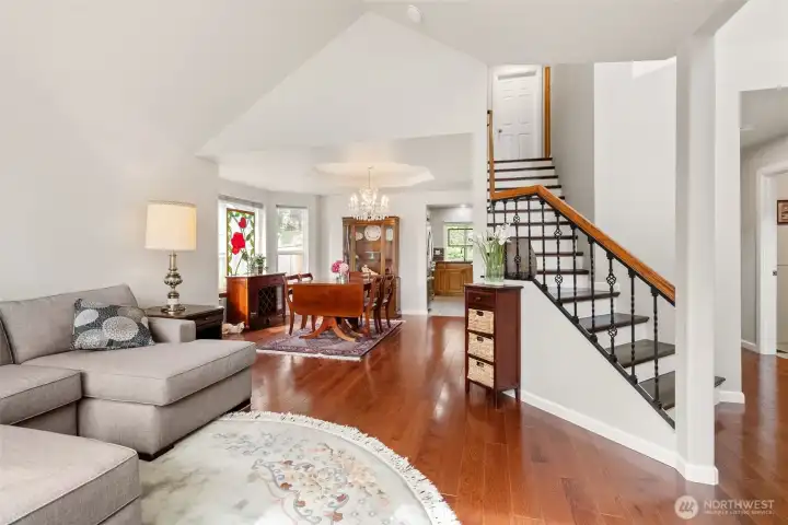 Rich hardwood floors paired with elevated ceilings create a warm, inviting atmosphere