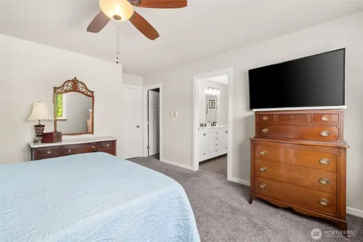 Spacious primary suite offering comfort and flexibility, with ample room to accommodate a queen-sized bed as shown