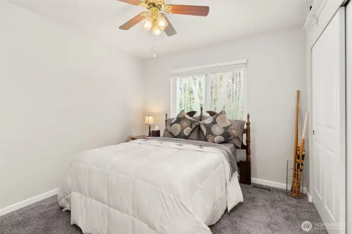 Second bedroom comfortably accommodates a queen-sized bed, offering both space and versatility.