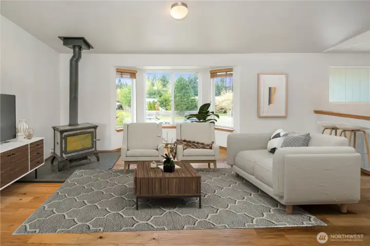 View of living room and bay window from the kitchen island *Virtually Staged*