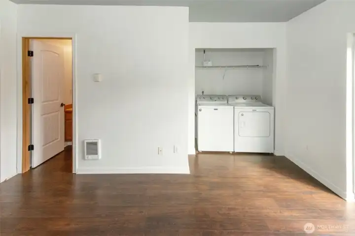 Laundry area and door into downstairs full bathroom